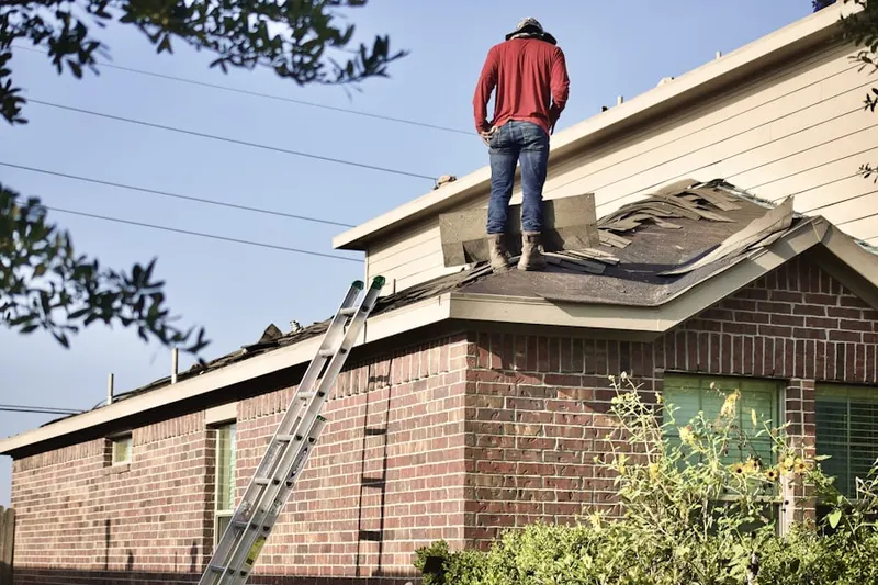 Professional roofer working on a residential roof in Covington Central Business District